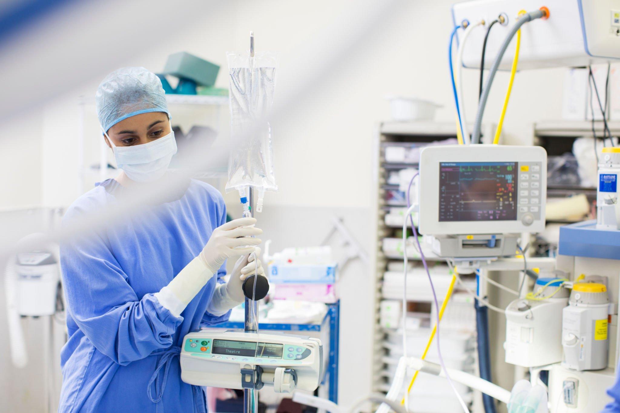 a nurse handling a advanced medical equipment image