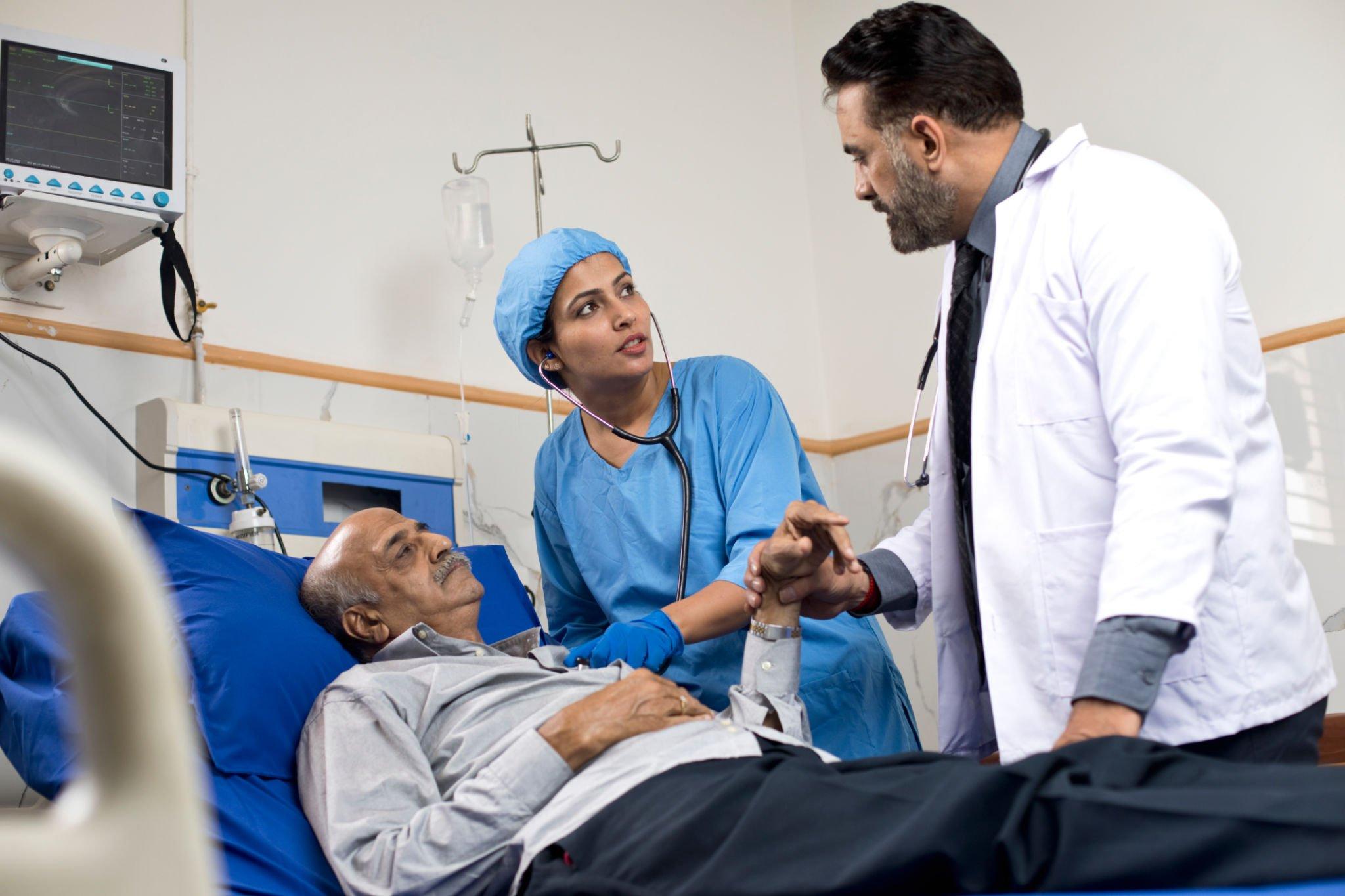 Two doctors checking the condition of a brain stroke patent
