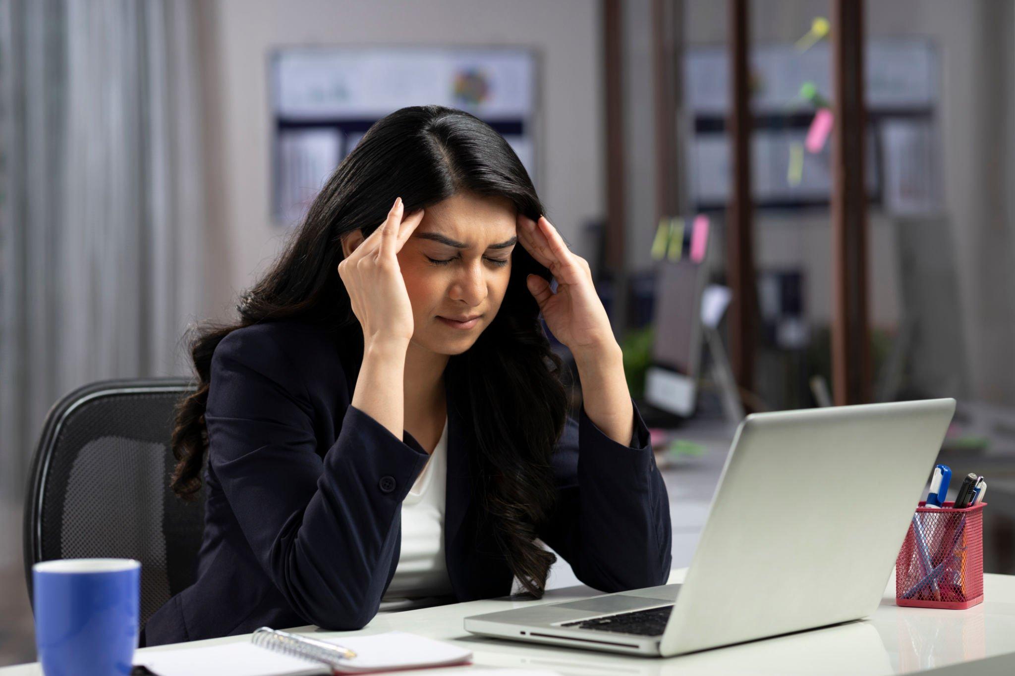 a girl having headache due to excessive work
